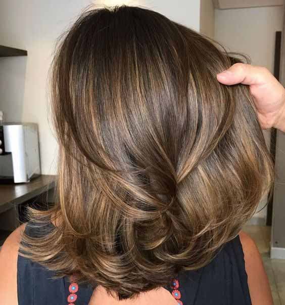 Coupe mi-longue dégradée avec un balayage miel