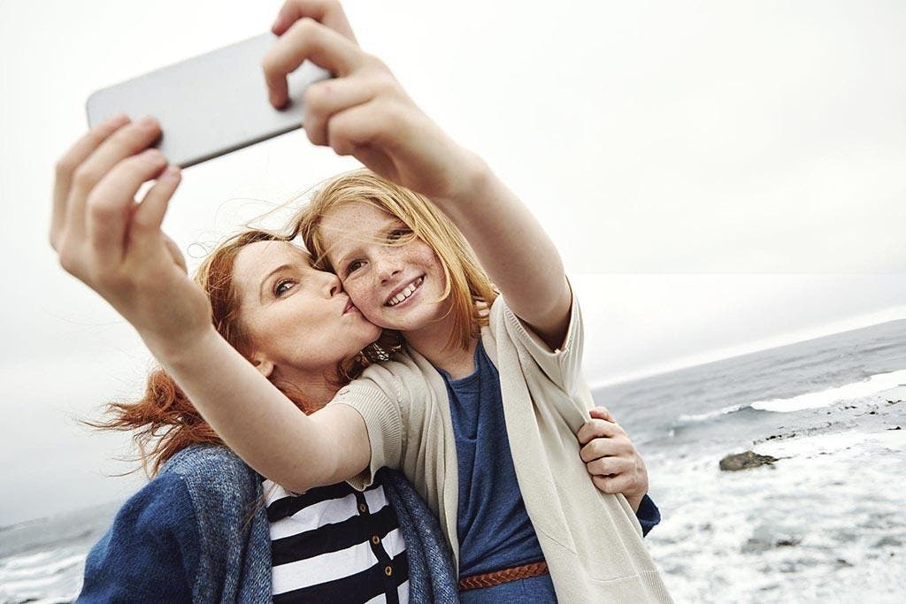 Enfant prenant un selfie avec sa mère