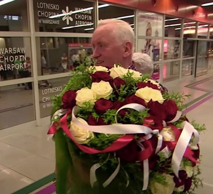 Lucian holding a bouquet of flowers