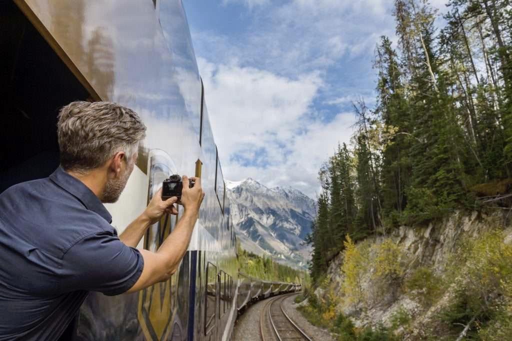 Un homme qui prend en photo la superbe vue du train