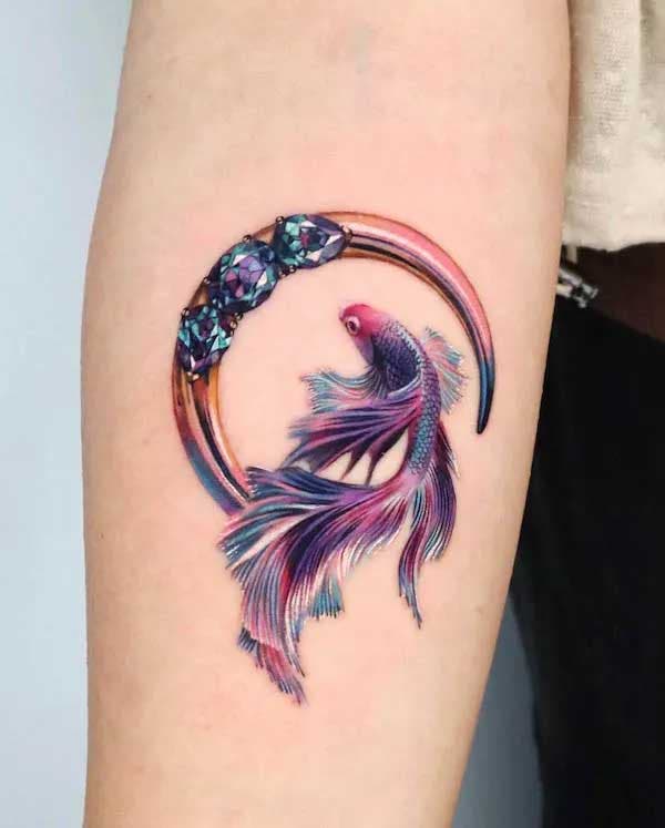 Tatouage de poisson et de lune sur l’avant bras
